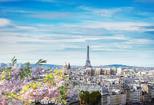 skyline of Paris city with eiffel tower from above in soft morning light with spring cloudscape, France