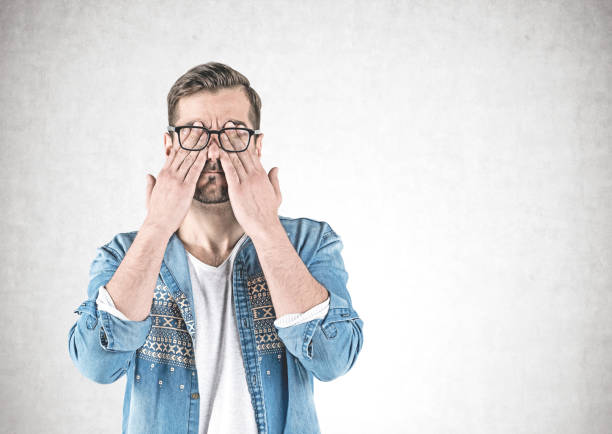 istock Casual man covering eyes with hands, concrete 1139152487