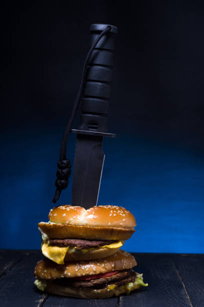 istock A large knife embedded in burgers. Double burger with meat. 1139156694