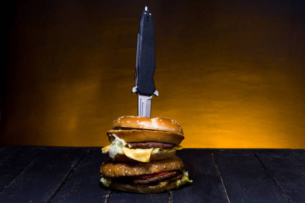 istock A pocket knife in a burger. Folding knife and burger. 1139156830