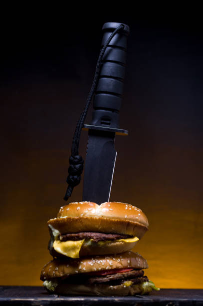 Large army knife in a burger. Killed burger.