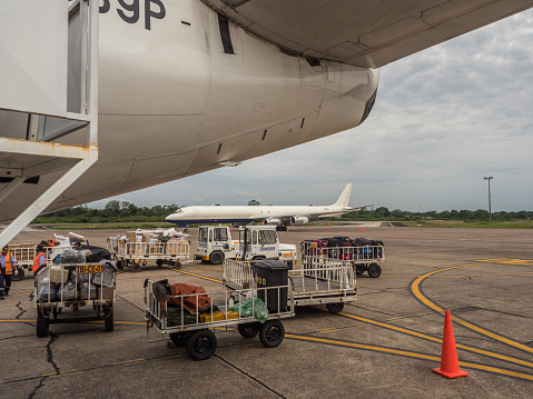 Iquitos, Peru - December 07, 2018: Luggage is waiting to be loaded onto an airplane at Iquitos airport. South America, Latin America