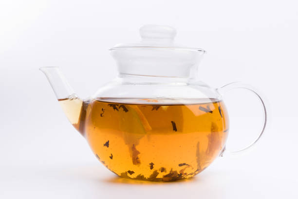 istock Glass teapot with black tea nad fresh orange isolated on white background 1139157887