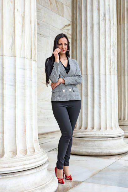 istock Beautiful woman standing beside marble column 1139163744