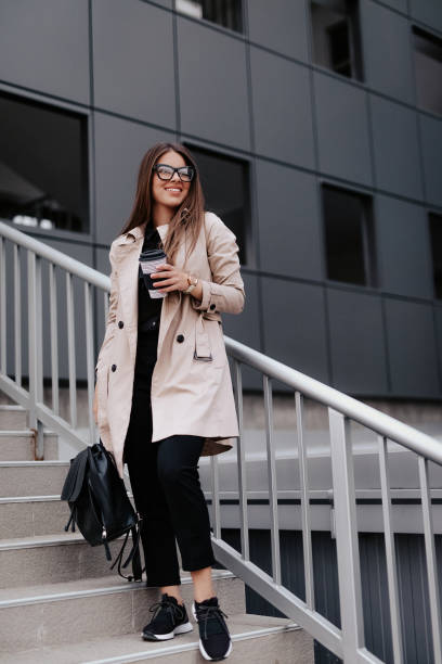 istock Woman outside business center drinking coffee 1139163814