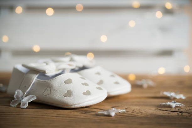 istock baby shoes on wooden table 1139164417