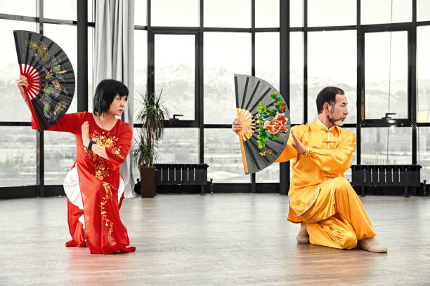 istock Couple of senior masters practicing qi qong taijiquan 1139166322