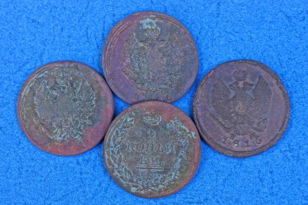istock four old brown coins lie on a blue table 1139168697