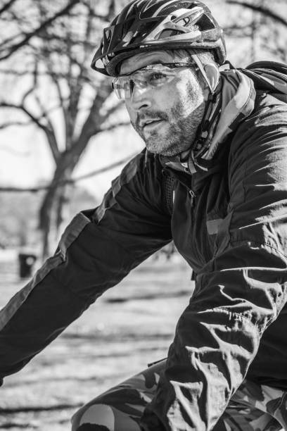 caucasian man biking in city park - ontario spring bicycle city life imagens e fotografias de stock