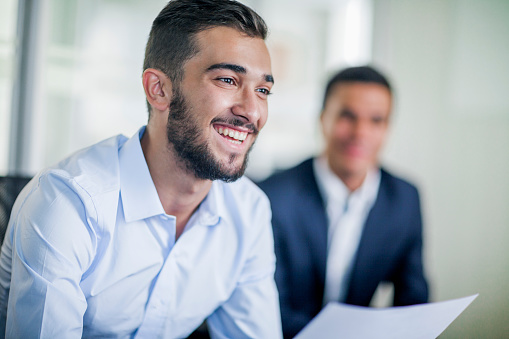 Business colleague smiling in office meeting