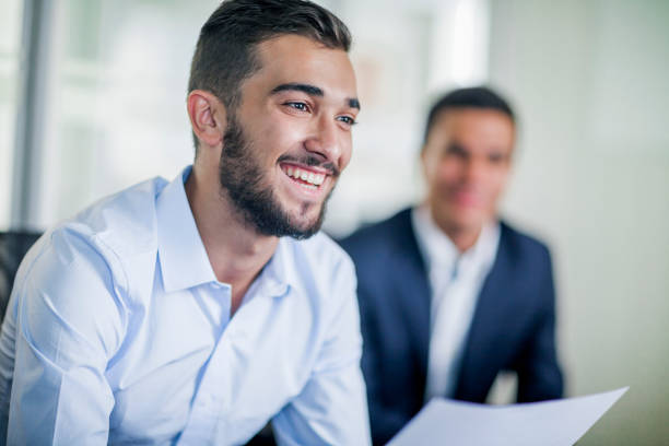 Business colleague smiling in office meeting Business colleague smiling in office meeting affirmative action photos stock pictures, royalty-free photos & images
