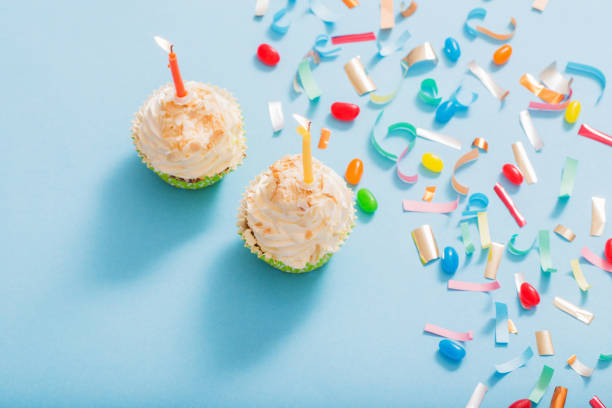 istock birthday hat with confetti and cupcake on blue paper background 1139177642