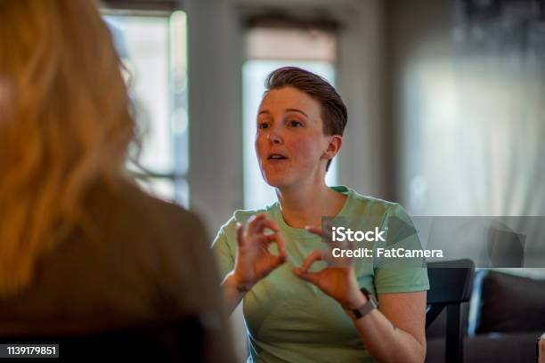 Deaf Woman Signs To Her Partner Stock Photo - Download Image Now - Sign Language, Deafness, American Sign Language