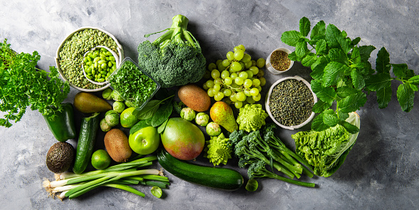 Variety of Green Vegetables and Fruits on the grey background