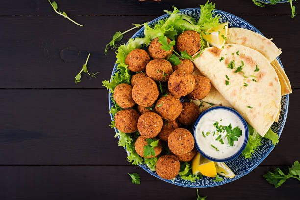 Falafel, hummus and pita. Middle eastern or arabic dishes on a dark background. Halal food. Top view. Copy space Falafel, hummus and pita. Middle eastern or arabic dishes on a dark background. Halal food. Top view. Copy space kosher starter recipes stock pictures, royalty-free photos & images