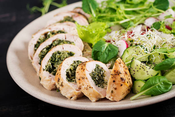 istock Baked chicken rolls with spinach and cheese on  plate. Healthy lunch. Keto diet. 1139182802