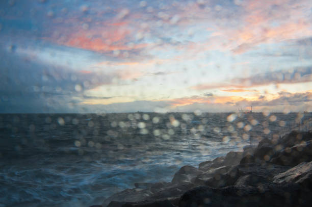 drammatica onda oceanica schizzo la sera con cielo crepuscolare in inverno al breakwater al molo di st kilda a melbourne in australia - melb foto e immagini stock