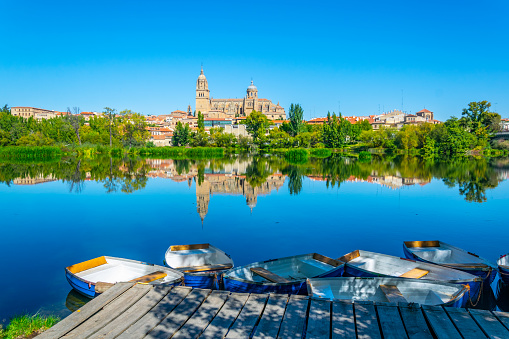 Boats mooring in front of the cathedral of Salamanca in Spain