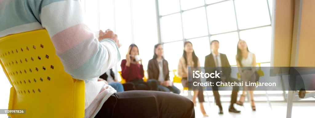 Group of people sitting at seminar, with relax time with coffee and listening to speaker. Education, conference, workshop concept. Education Training Class Stock Photo