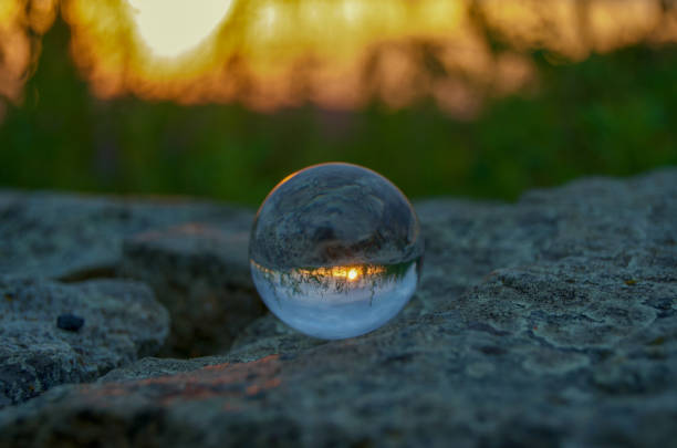 istock Light from sunrise coming over mountains and reflected in crystal ball 1139198680