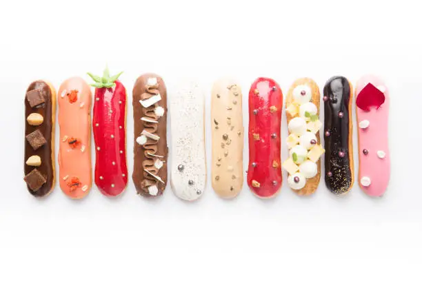 Photo of Group of french dessert Eclair on white background