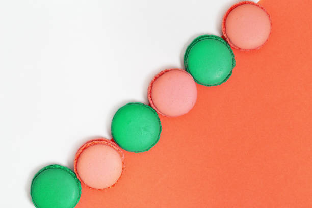 istock Sweet colorful macaroons in row. Bright macaroon biscuits close up on paper background. Top view. 1139200422