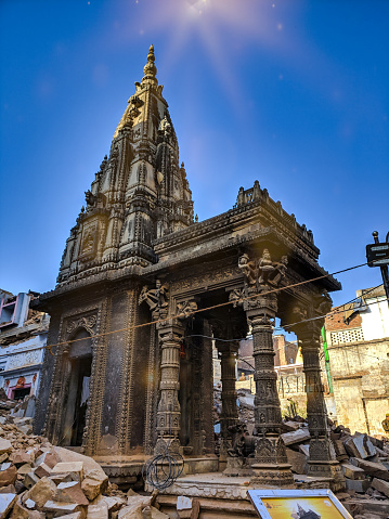 Centuaries old temple stands tall on debris after it was strippewd off its boundaries during demolition of old houses to make space for Vishwanath Temple Corridor Project near Manikarnika ghat in Varanasi, Uttar Pradesh.