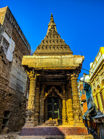 Centuaries old temple stands tall on debris after it was strippewd off its boundaries during demolition of old houses to make space for Vishwanath Temple Corridor Project near Manikarnika ghat in Varanasi, Uttar Pradesh.