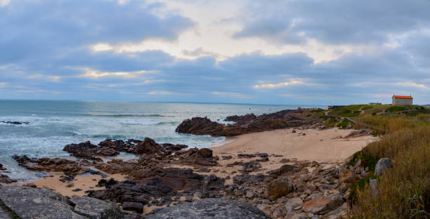 istock Panoramic of beach with church over the hill 1139201587