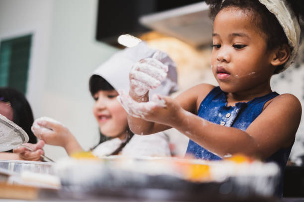 istock Group diversity kids girl making cake bakery in kitchen 1139205930