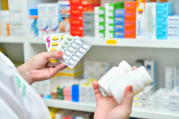 istock Pharmacist holding medicine pack and medicine bottle 1139206614