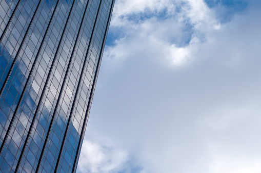 Glass windows of a skyscraper with blue sky reflections