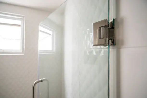 Photo of Door hinges on glass door in bathroom for wet zone - can use to display or montage on product