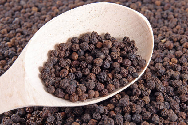 istock black pepper on wooden spoon 1139216803