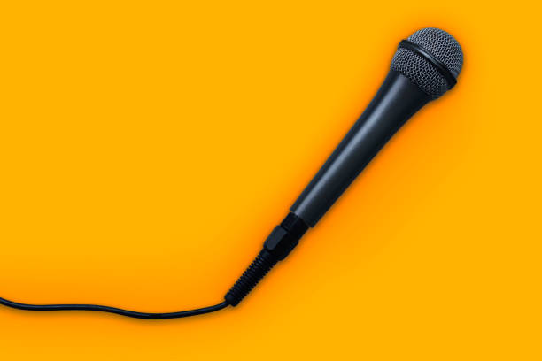 istock Black Microphone isolated on yellow background - Clipping path 1139220775
