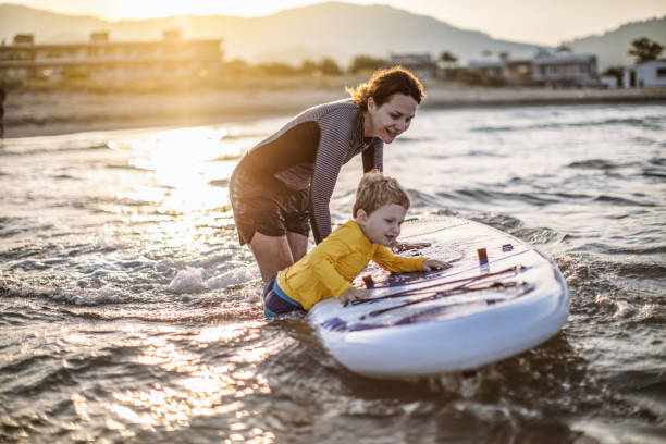 istock Mother and son having fun with paddle board 1139220949