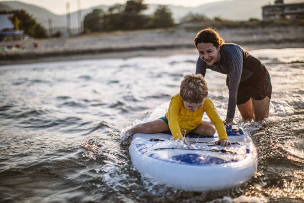 istock Mother and son having fun with paddle board 1139221542
