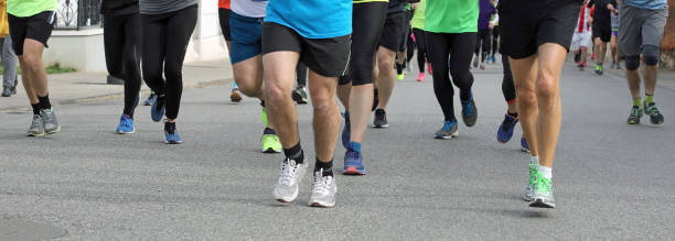 istock many runners with snakers on the road 1139221671