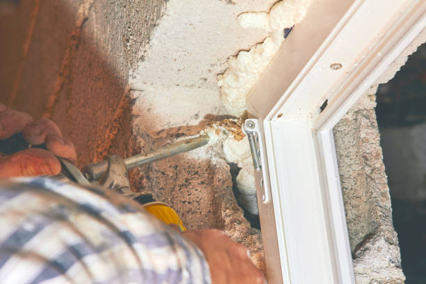 istock Construction worker puts expandable foam on the PVC window for insulation. 1139222085
