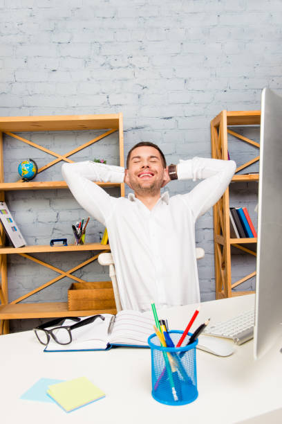istock Handsome happy office worker having break and relaxing after work 1139225483