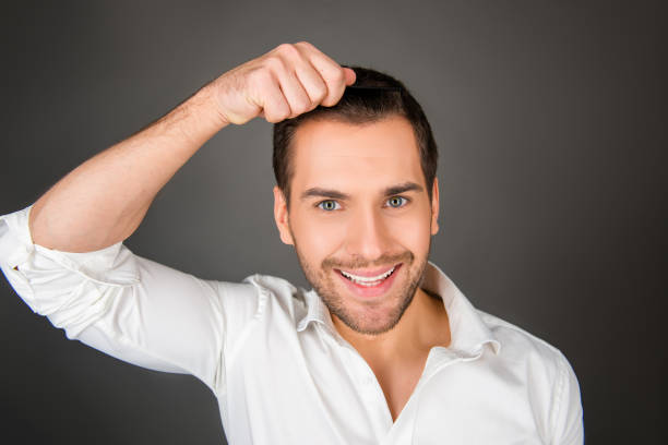 istock Smiling young man making a hairdress 1139226218