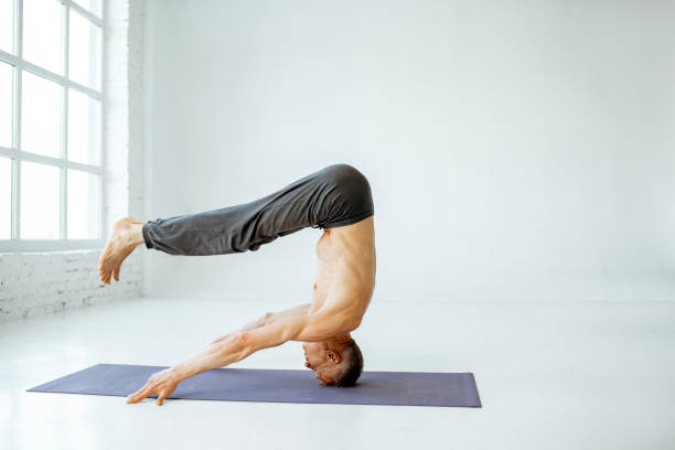 istock Senior man practising yoga indoors 1139227276