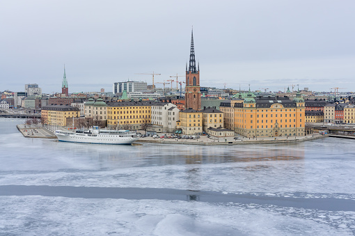 Stockholm Old town in a cloudy day in February from the viewpoint with the frozen channel.