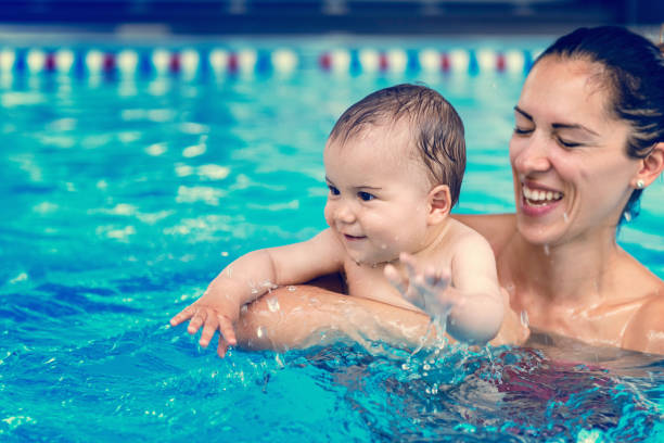 istock Happy Mother And Son Swimming In Pool 1139234413