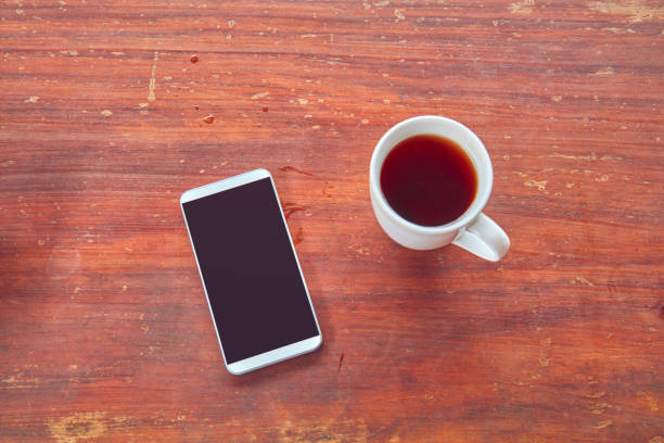 istock Morning ritual with cellphone and coffee / tea. 1139238304