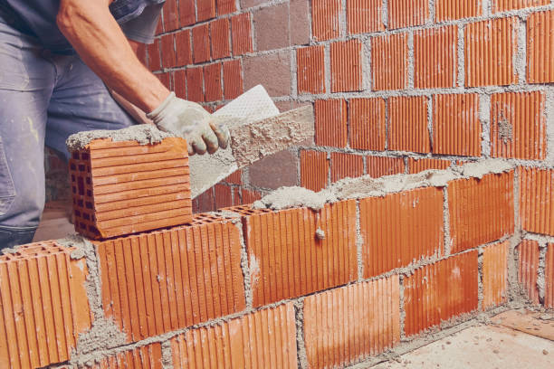 Real construction worker bricklaying the wall indoors. Real construction worker bricklaying the wall indoors. artillery photos stock pictures, royalty-free photos & images