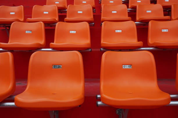 istock A lot of orange chairs in the stadium. 1139242575