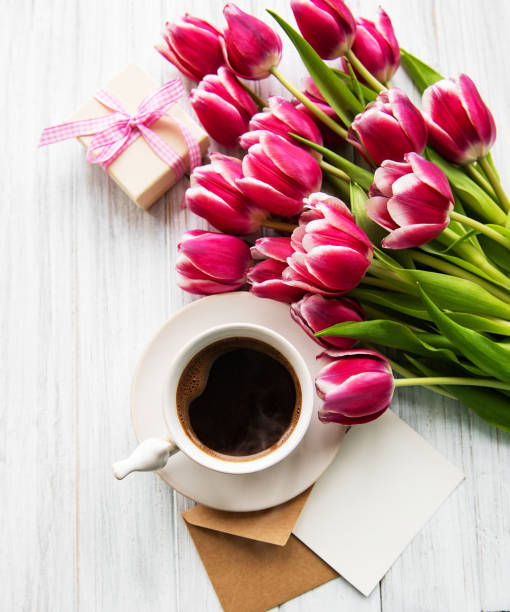 istock Cup of coffee and pink tulips 1139243705