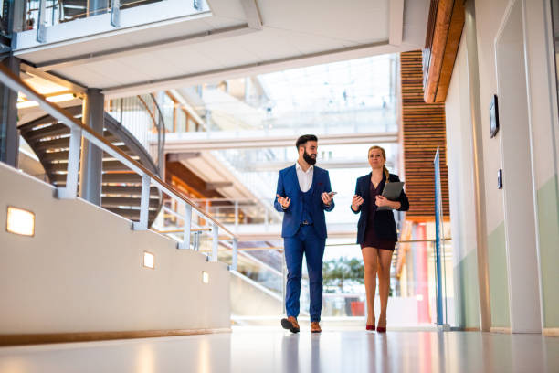 istock Two business people walking in business hall. 1139244190