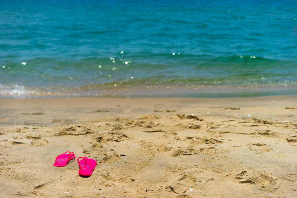 istock pink light sandal on the beach 1139246294